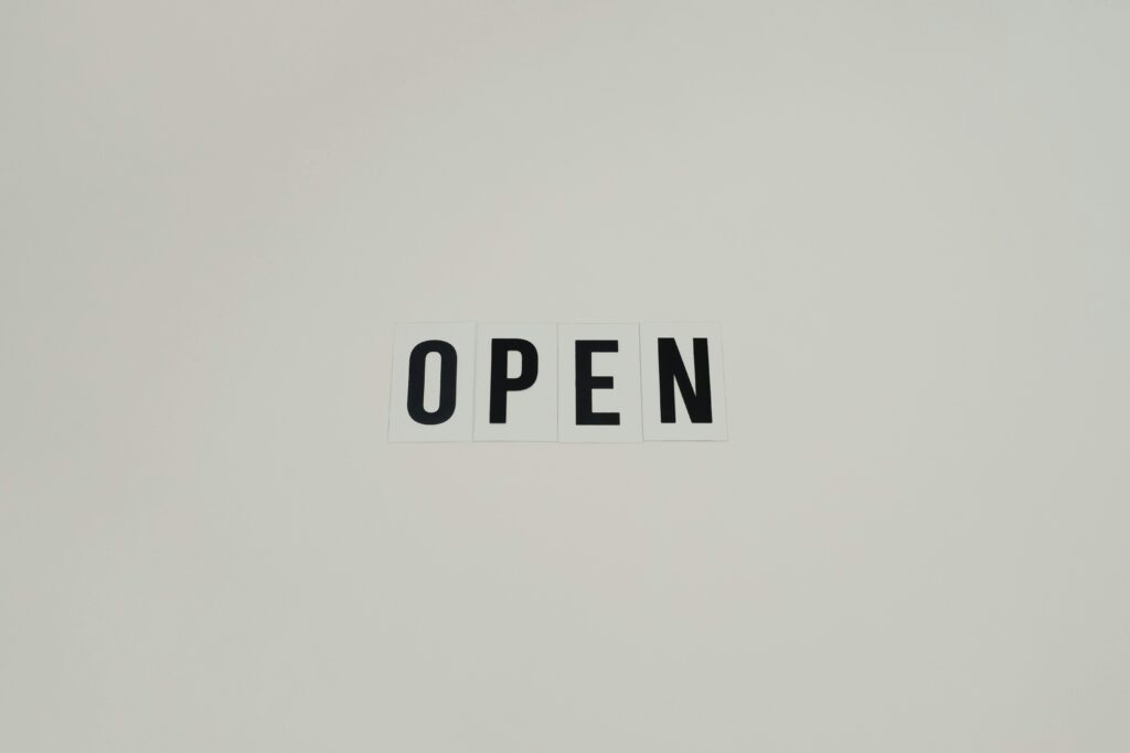 Simple and minimalist text reading 'OPEN' on a white background, ideal for business use.